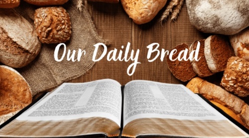 A book open on a table with bread Description automatically generated