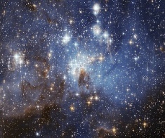 A galaxy with stars and clouds Description automatically generated with medium confidence